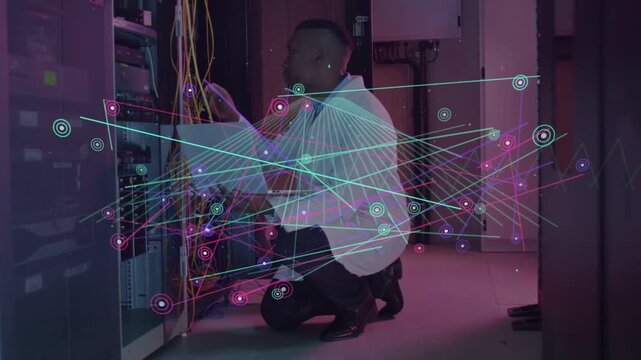 Male tech viewing tablet and patching cables into rack ports, ensuring network, nodes overlaying