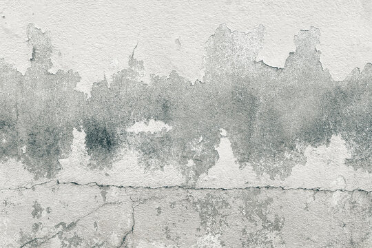 Weathered concrete wall with peeling paint, cracks, and rough texture, abstract grunge background in gray tones, ideal for industrial or vintage design use.