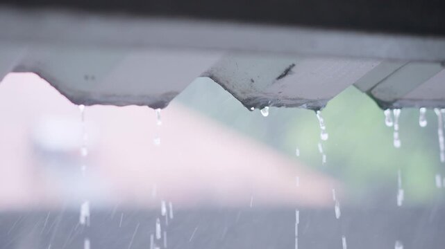 Cinematic Rain Water Dripping from Zinc Roof Eaves in Slow Motion