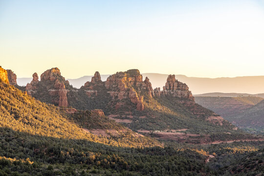 Jagged red rock formations in sedona landscape at sunset