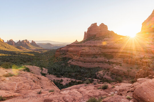 Bright sunburst flare on Sedona red rock formation
