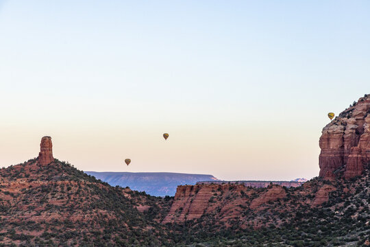 Hot air balloons over red rock formations
