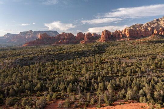 Red rock formations above forested landscape