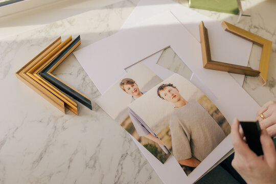 Framing printed portraits on marble tabletop