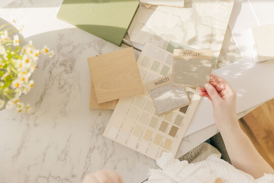 Interior designer choosing neutral fabric swatches