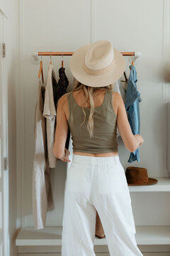 Rear view of stylish woman selecting clothes