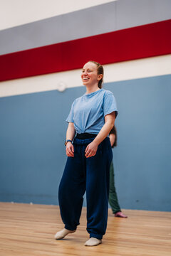 Woman smiling and dancing during fitness activity