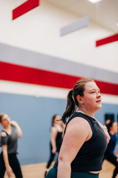 Young woman enjoying group fitness dance workout