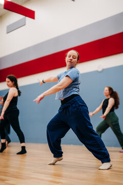 Female dancers practicing contemporary movement in studio class