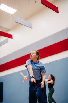 Woman reaching forward during dance fitness class in studio