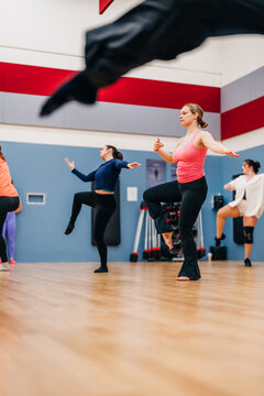 Women learning dance moves during a fitness class