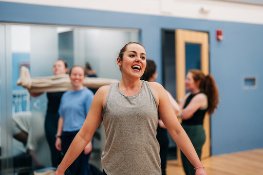 Woman smiling laughing during group fitness class