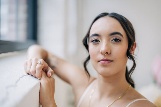 Woman posing wearing septum ring and diamond ring