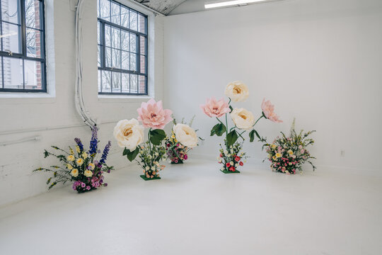 Giant paper flowers creating whimsical floral installation decor