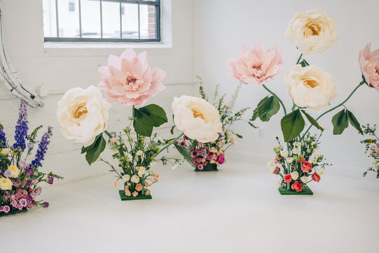 Giant paper flowers creating whimsical floral installation decor