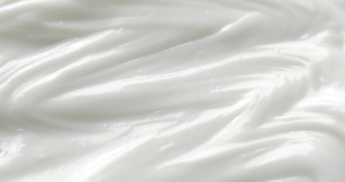 Cosmetic smears of creamy texture. Cosmetic skin cream. Beauty skincare product sample. Close-up footage of cream texture on rotating table