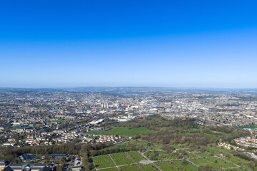 Obraz premium Aerial view of a large cemetery in Bradford West Yorkshire with gravestones pathways and surrounding residential housing captured from above in natural daylight in the early spring season