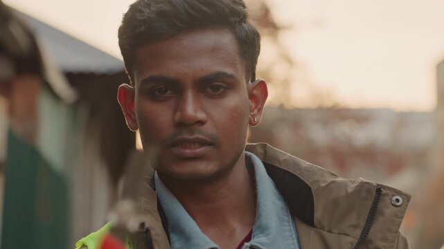 Asian maintenance worker evening repair focus, closeup with tool motion toward camera, safety vest catching warm glow, urban corridor backdrop, expressions shifting from calm to resolute, cinematic