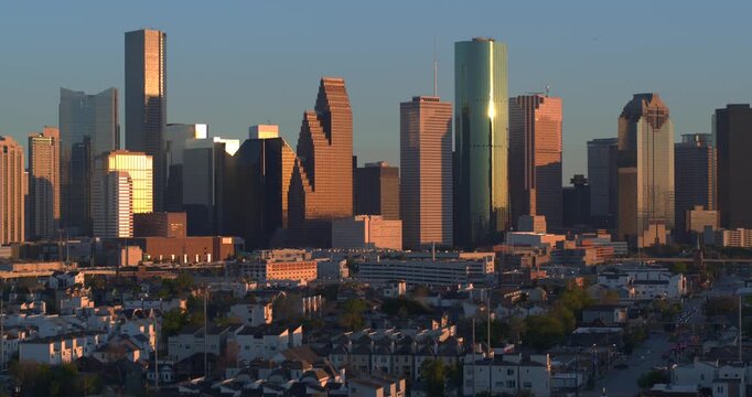 Descending view of I-45 North Freeway Cars Flowing with Downtown Houston Skyline in background