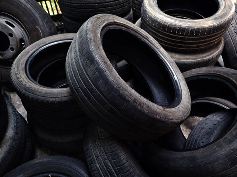 Outdoor storage area with aged tires emphasizing recycling and reuse opportunities