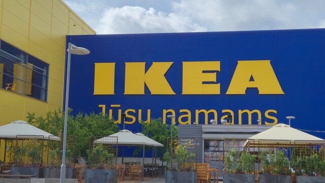 Vilnius Lithuania 19.06.2025 ikea store exterior with large yellow logo on blue facade and outdoor cafe seating area showcasing modern retail architecture and shopping environment