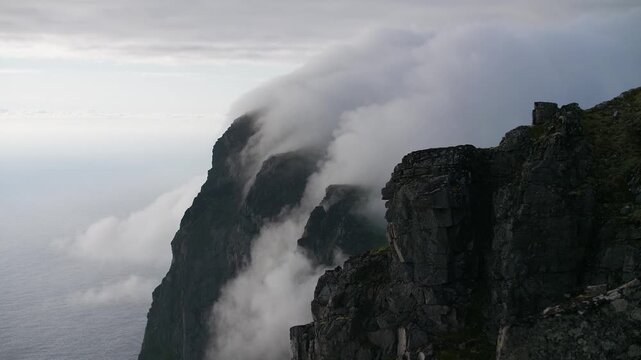 Sea fog rolling over coastal cliffs Norway