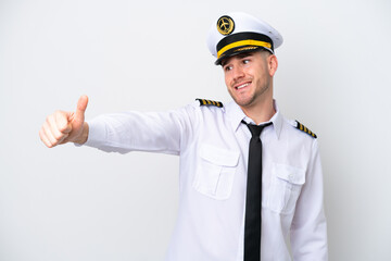 Airplane caucasian pilot isolated on white background giving a thumbs up gesture © luismolinero