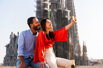 Obraz premium Multiracial beautiful happy couple of lovers dating in Barcelona on a rooftop with amazing city view