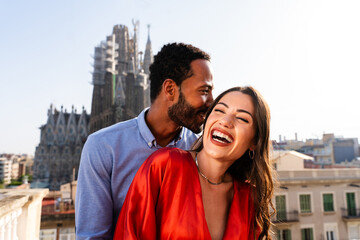 Obraz premium Multiracial beautiful happy couple of lovers dating in Barcelona on a rooftop with amazing city view