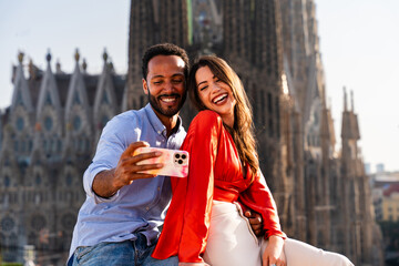 Obraz premium Multiracial beautiful happy couple of lovers dating in Barcelona on a rooftop with amazing city view