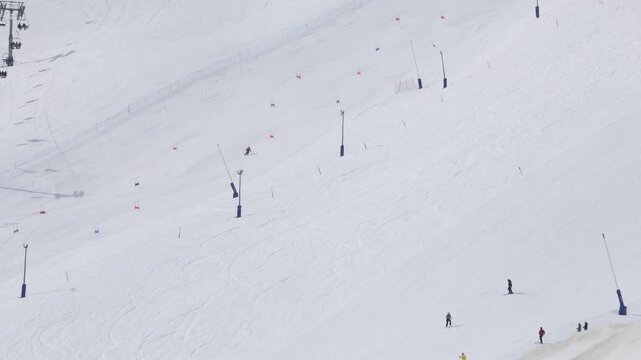 Skiers riding chairlift at Pas de La Casa ski resort