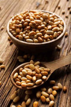 Pine nuts on a wooden spoon, close up view