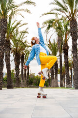 Beautiful red haired young woman with rollerskates having fun outdoors