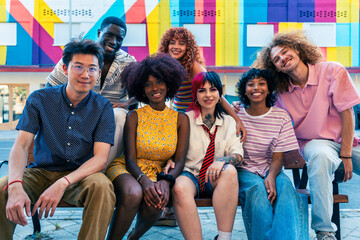 Multiethnic group of young friends meeting and having fun outdoors - Multiracial teenagers hanging out, concepts about youth, lifestyle