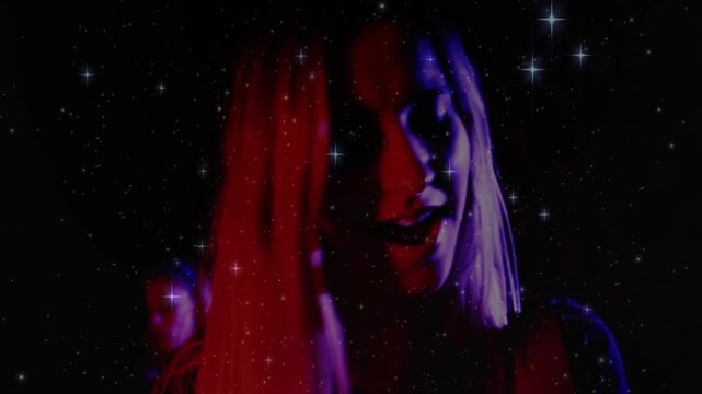 Camera rolling lead moving mouth or head leaning to backup under starfield red purple lights music