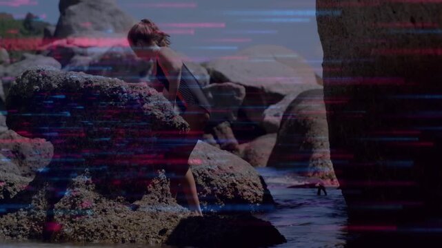 Vertical video: Leaning girl in one-piece suit stepping down barnacles to explore pools, copy space