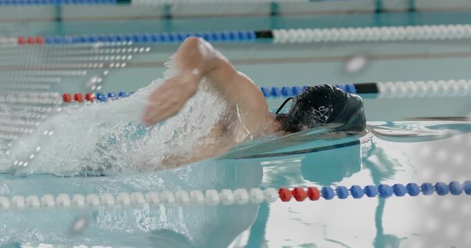 Swimmer appearing as pulsing code overlay reveals ripples, doing freestyle laps for sports tech