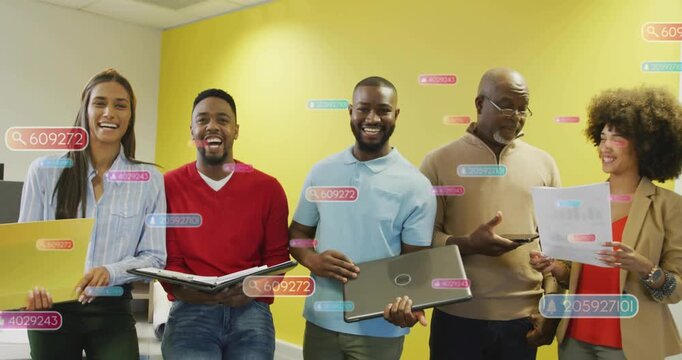 Team opening binder and tipping laptop in business review, causing floating labels over yellow wall