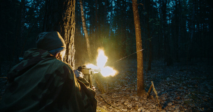 Red army soviet russian soldier soldier firing machine gun with large muzzle flash in night battle