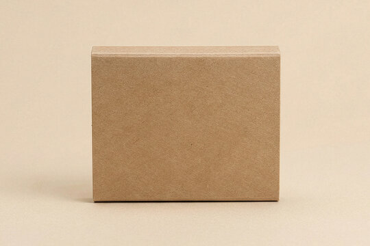 Small flat rectangular blank kraft cardboard box on a beige background