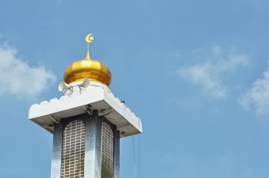 Mosque Minaret with Golden Dome and Blue Sky