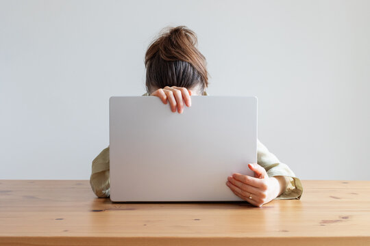 Tired and anxiety woman with laptop in stress at home working desk facing problems with office overwork, deadline and crisis. Mental health burnout, depression and despair concept.