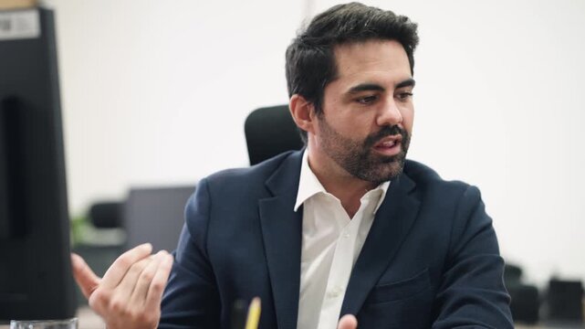 Professional male entrepreneur talking and gesturing during a business conversation. Focused company manager explaining his ideas in the workplace