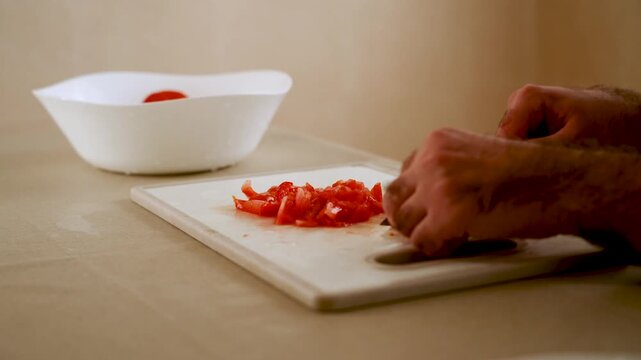 Slicing tomatoes for fresh salads and sauces in a simple kitchen setting