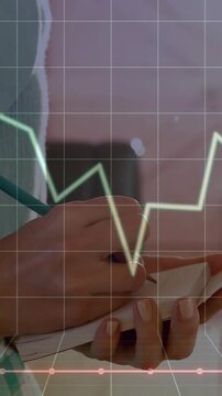 Vertical video: Clinician tapping device, writing notes, grid and line chart showing patient trend
