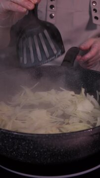 When preparing the vegetable base for the soup, the cook mixes finely chopped onions in a saucepan