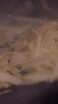 When preparing the vegetable base for the soup, the cook mixes finely chopped onions in a saucepan