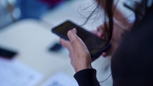 Closeup of a girl using a smart phone to scan a QR code to access information
