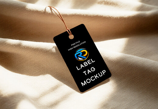 Black Label Tag Mockup on Beige Fabric Background with Sunlight and Soft Shadows
