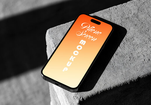 Smartphone Screen Mockup on Concrete Surface with Harsh Sunlight and Shadows
